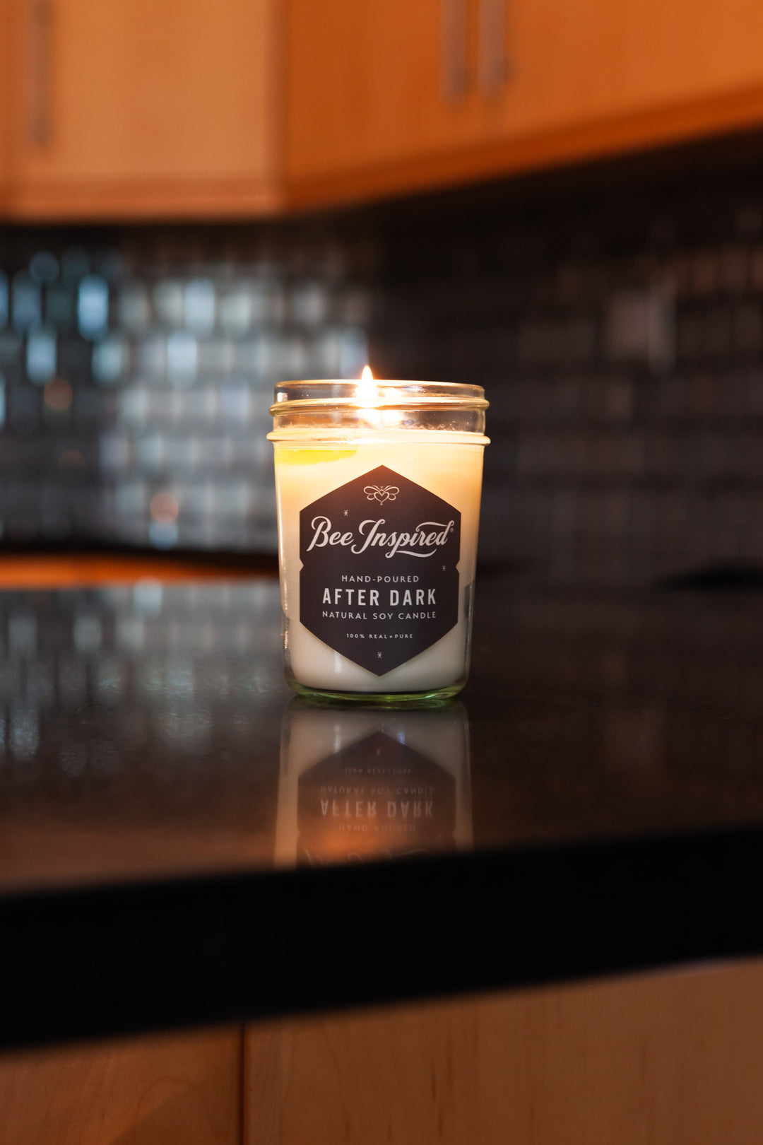 After Dark jelly jar candle burning on counter 