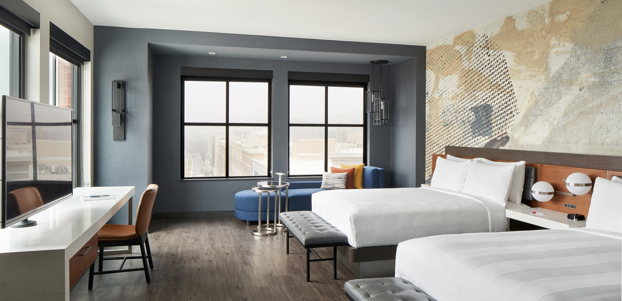 Bedroom with white, blue, and gold painting on the wall 