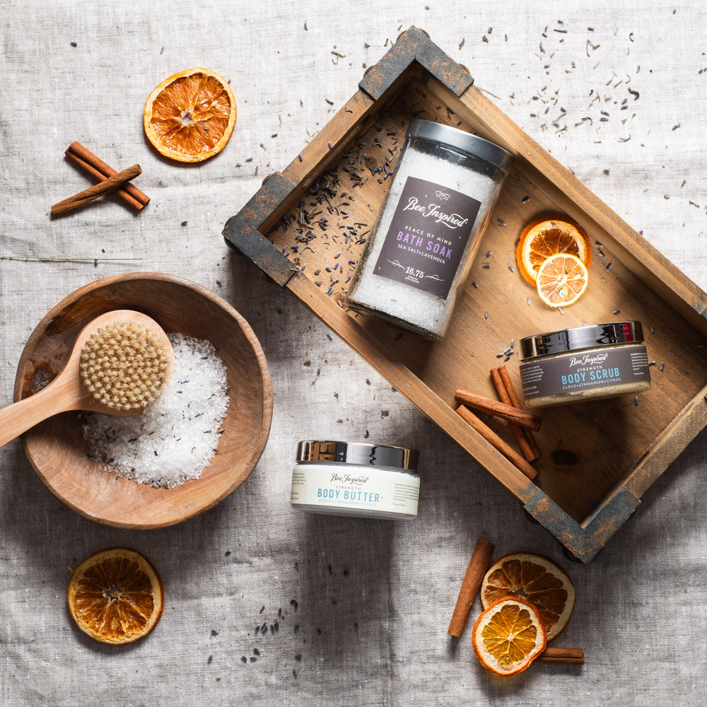 Foot Care Kit flat lay with cinnamon and dried orange slices on wooden trays 