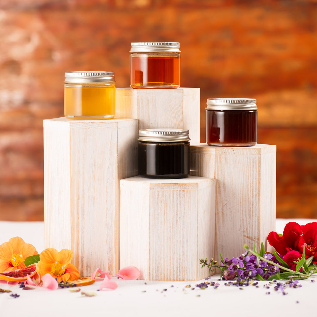 Honey gift set on birch displays with flower petals 