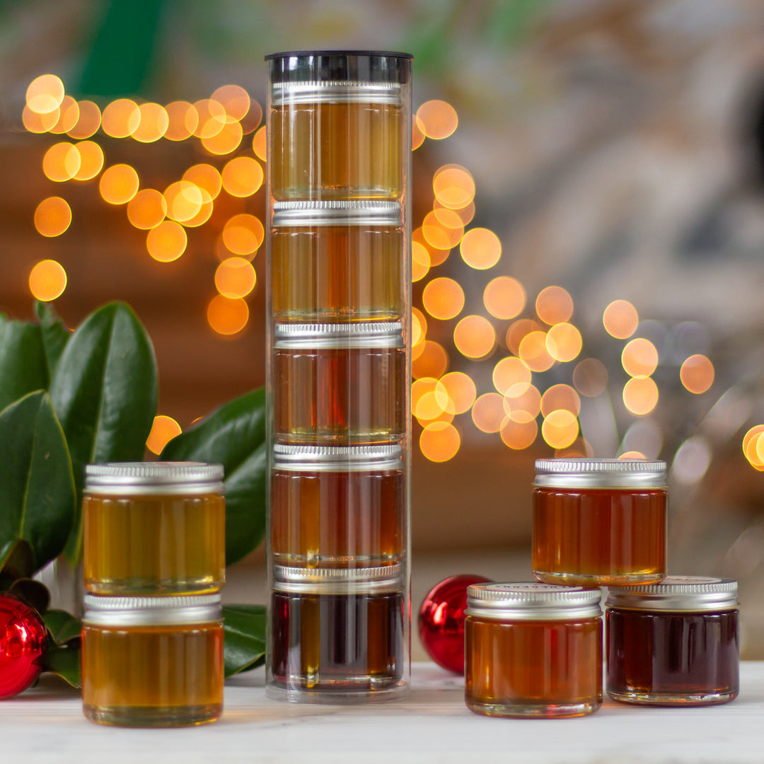 Honey Tasting Tower in front of holiday decorations and lights 