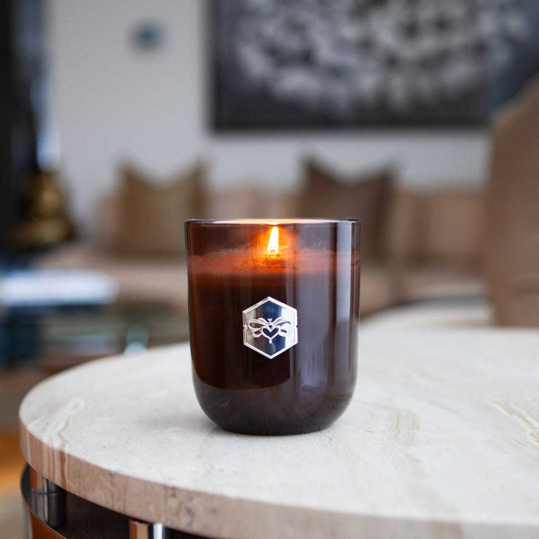 Luxe candle burning on living room table 