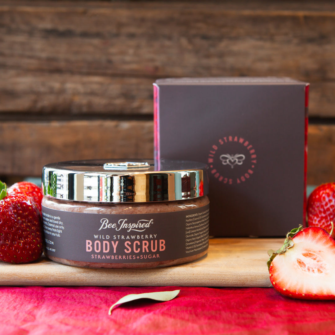 Wild Strawberry body scrub and box with fresh strawberries 