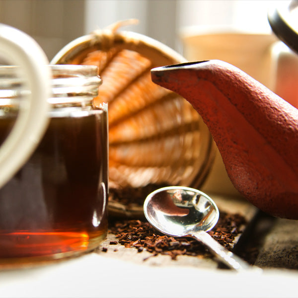 Jar of honey, tea kettle, and loose-leaf tea 