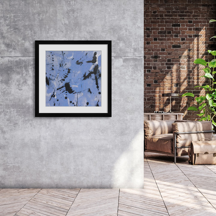 Blue and black framed artwork hanging on living room wall 