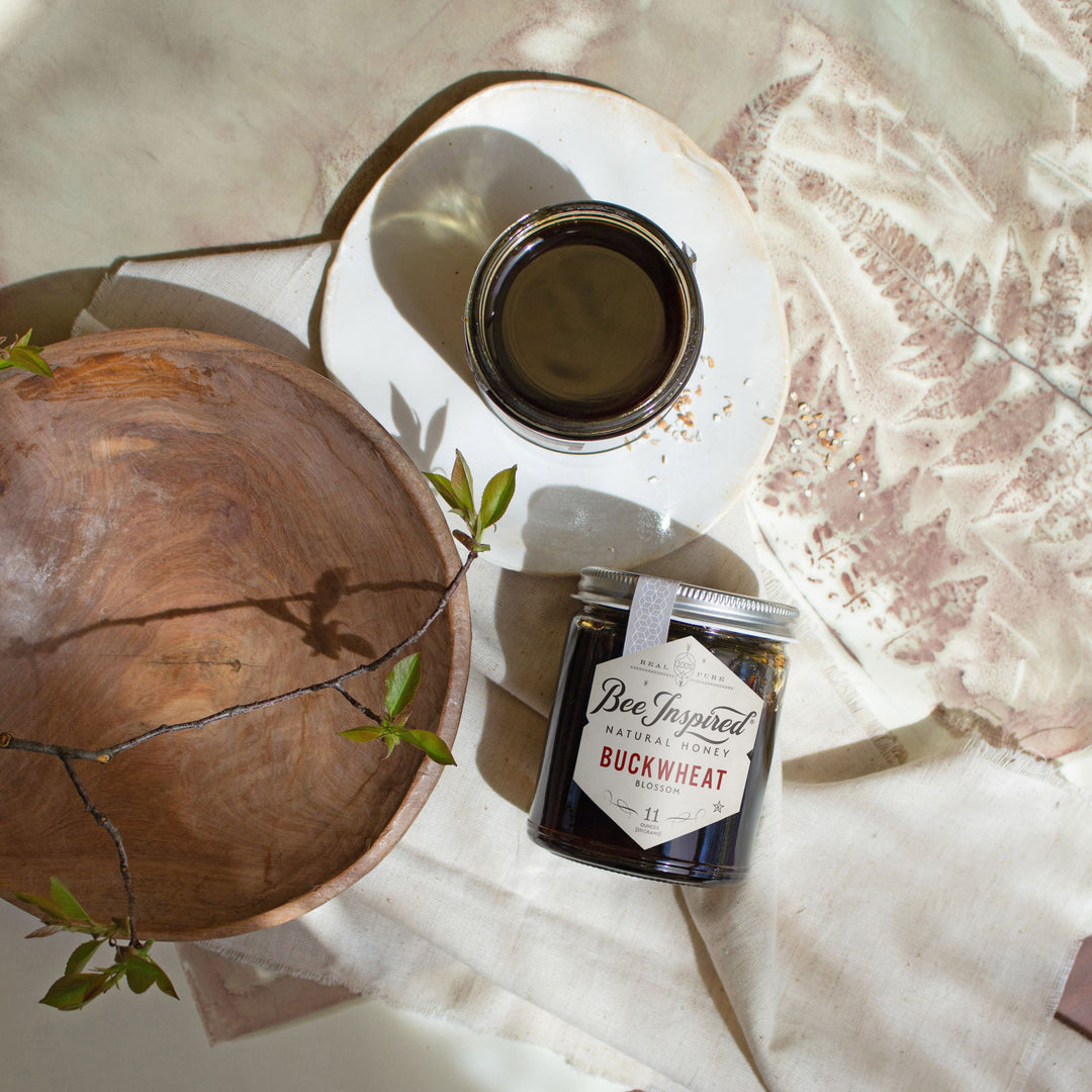 Buckwheat honey on set with art and wood bowl