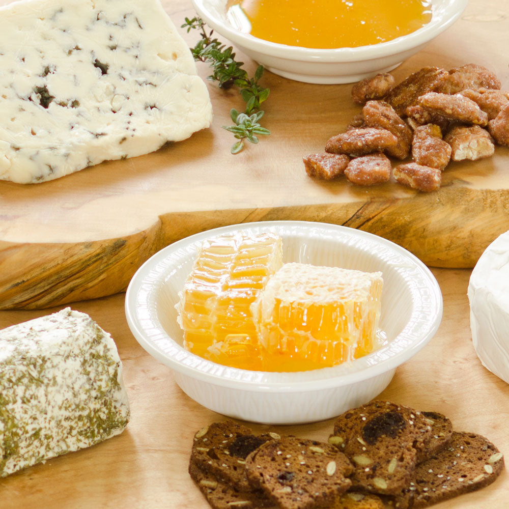 honeycomb on cheese board with crackers and nuts