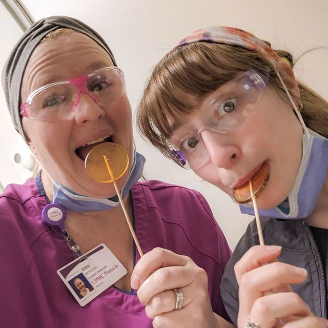 two nurses in their uniforms eating honey lollipops from bee inspired honey retail store in owings mills