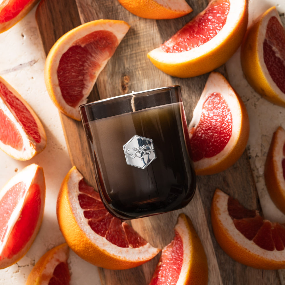 Ruby Red Grapefruit luxe candle flat lay on grapefruit slices 