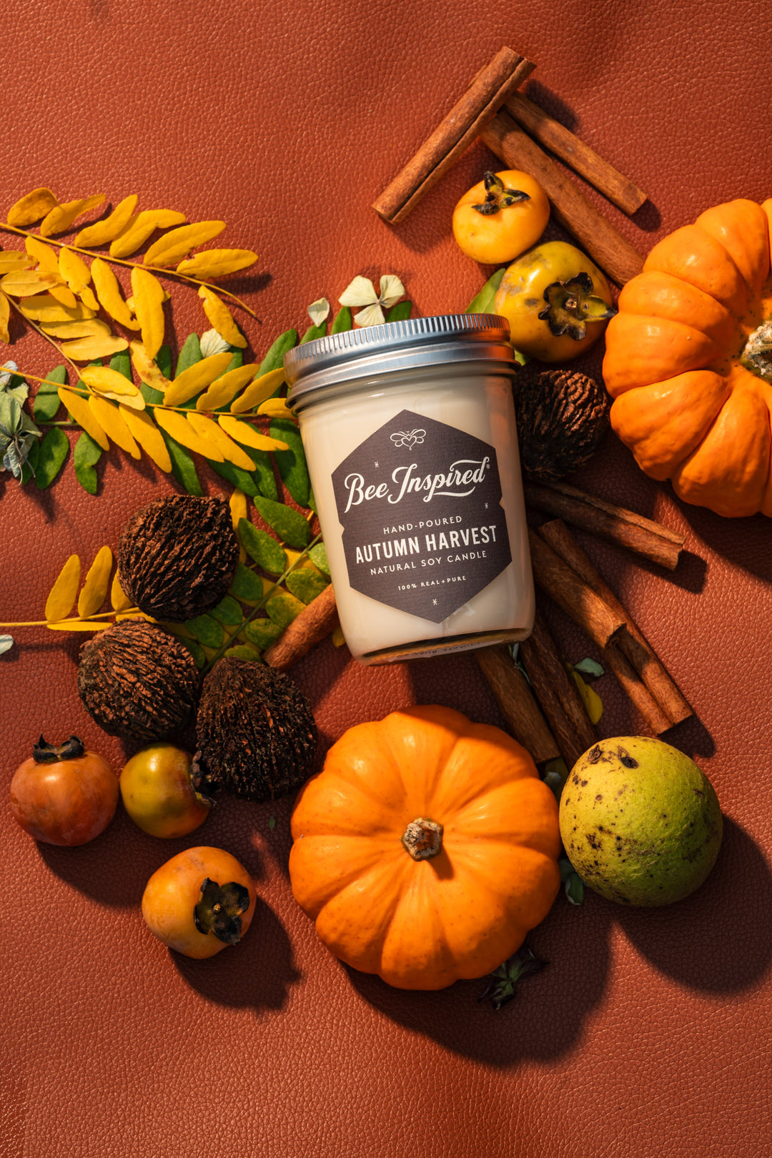 Autumn Harvest jelly jar candle flat lay with pumpkins and cinnamon sticks 