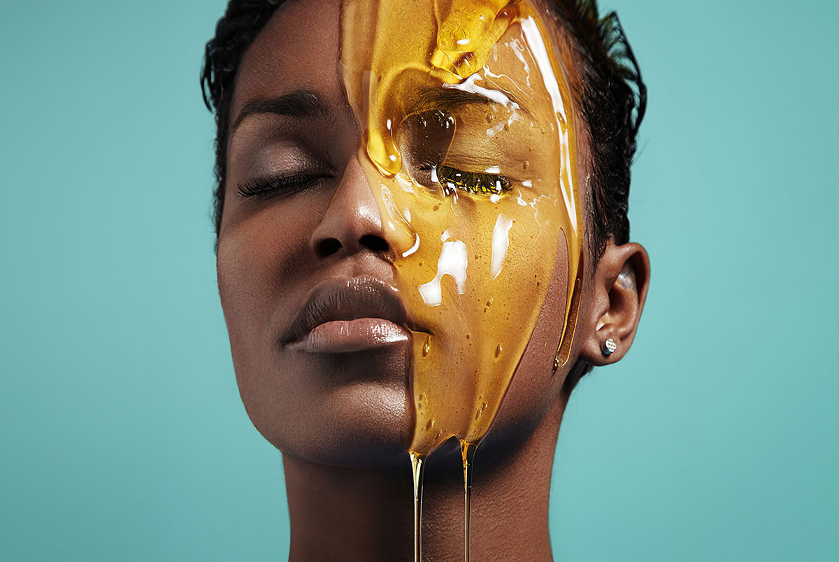 Woman has honey poured on half her face 