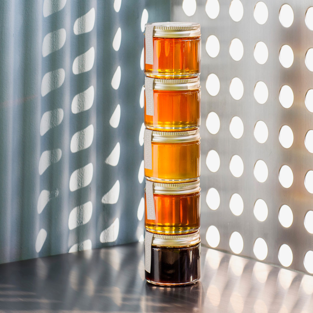 Honey Tasting Tower in front of lighted wall