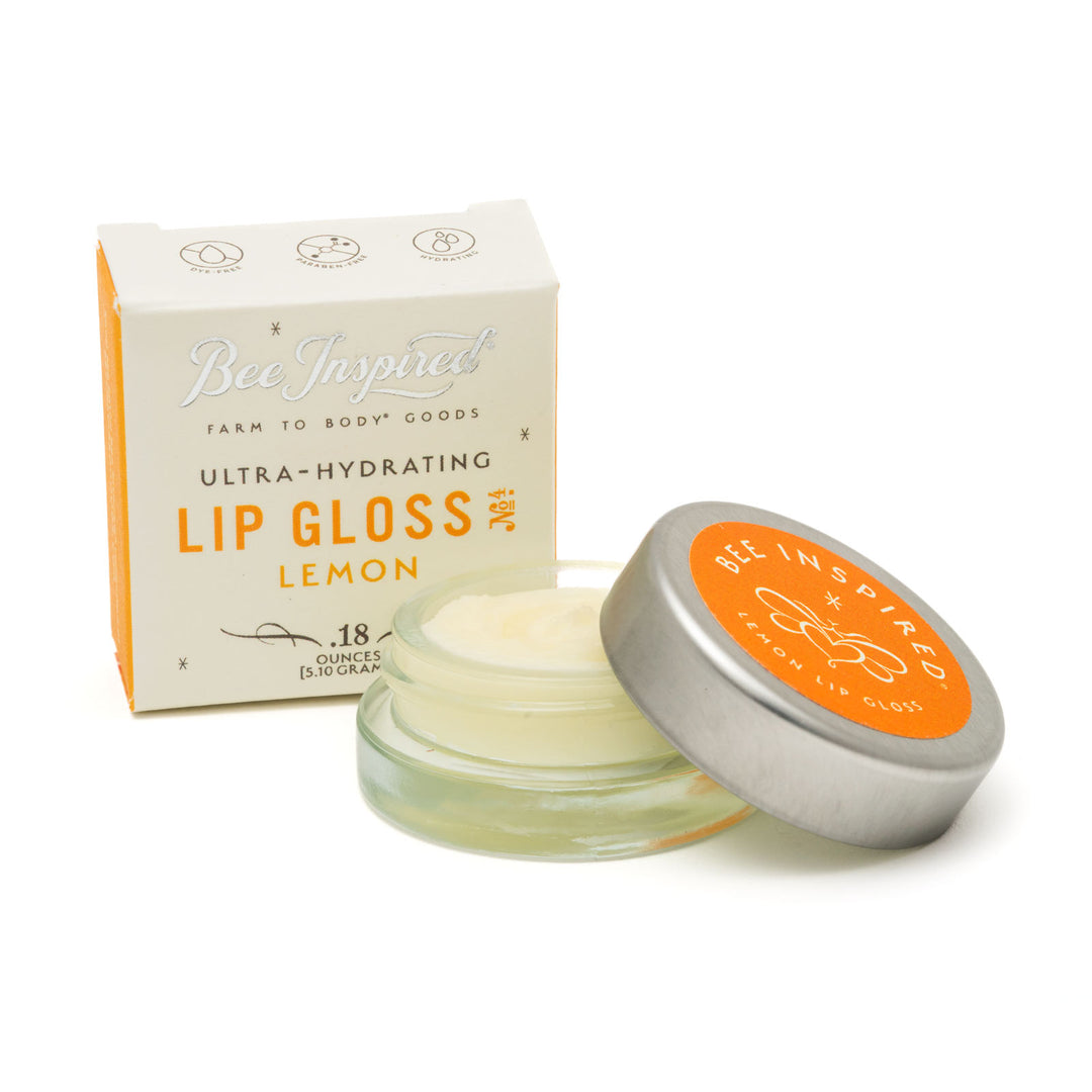 Lemon lip gloss and box on white 