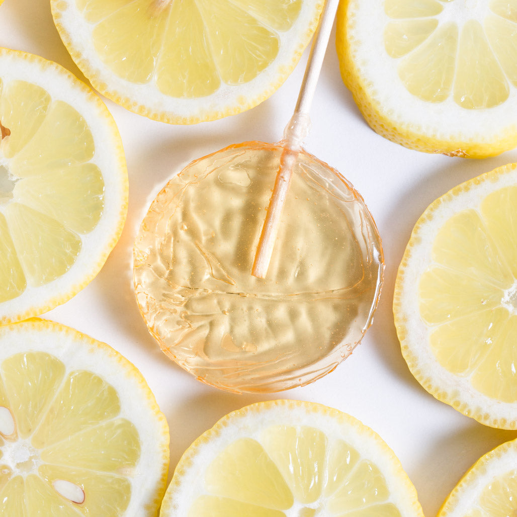 lemon lollipop from bee inspired honey retail store in owings mills surrounded by lemon slices