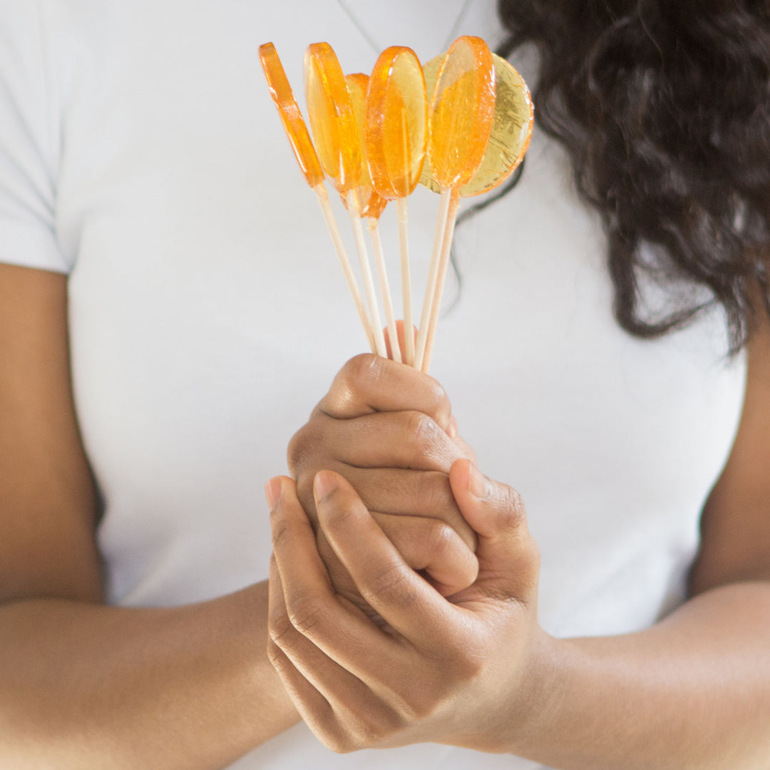 Woman holding bouquet of lollipops 