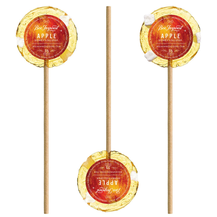 Apple honey lollipops with stickers against white 