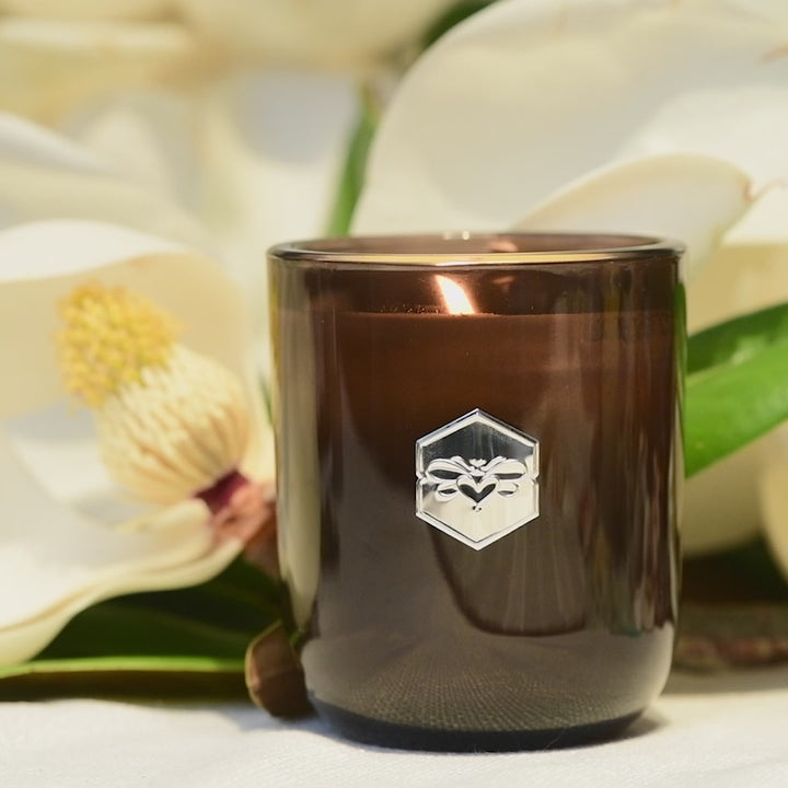 wild honeysuckle luxe candle from bee inspired honey retail store in owings mills flickering