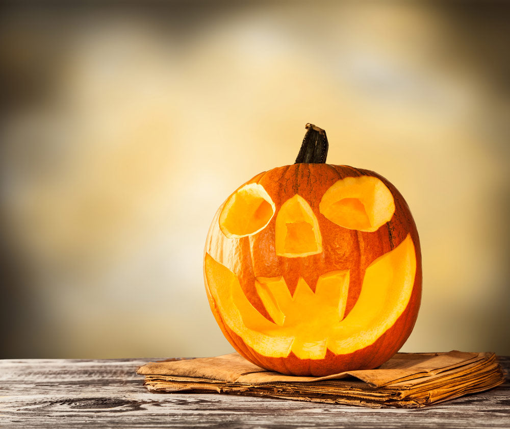 carved pumpkin on wooden table 