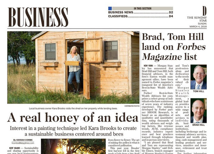 Image of Business section in newspaper featuring Kara holding a hive tray 