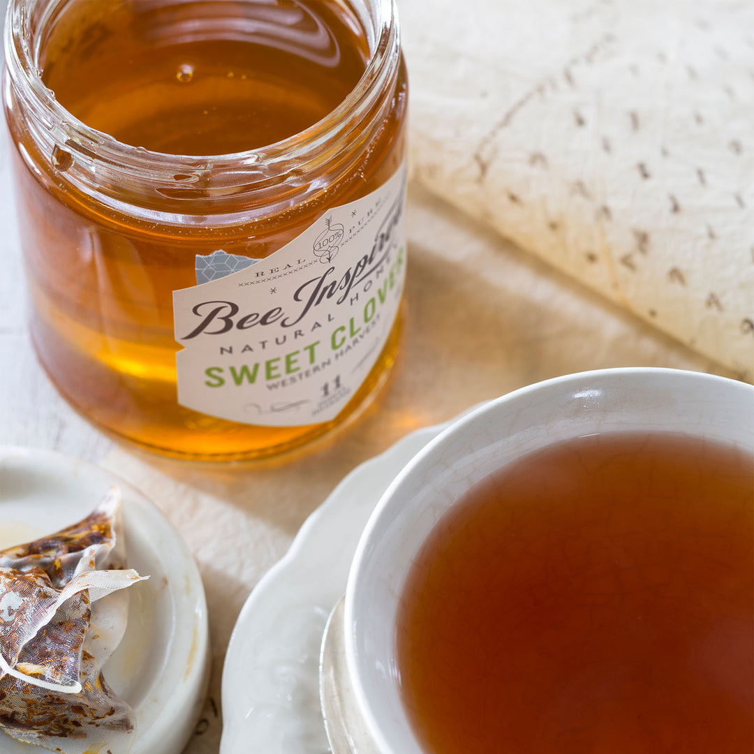 Sweet Clover honey next to mug of tea 